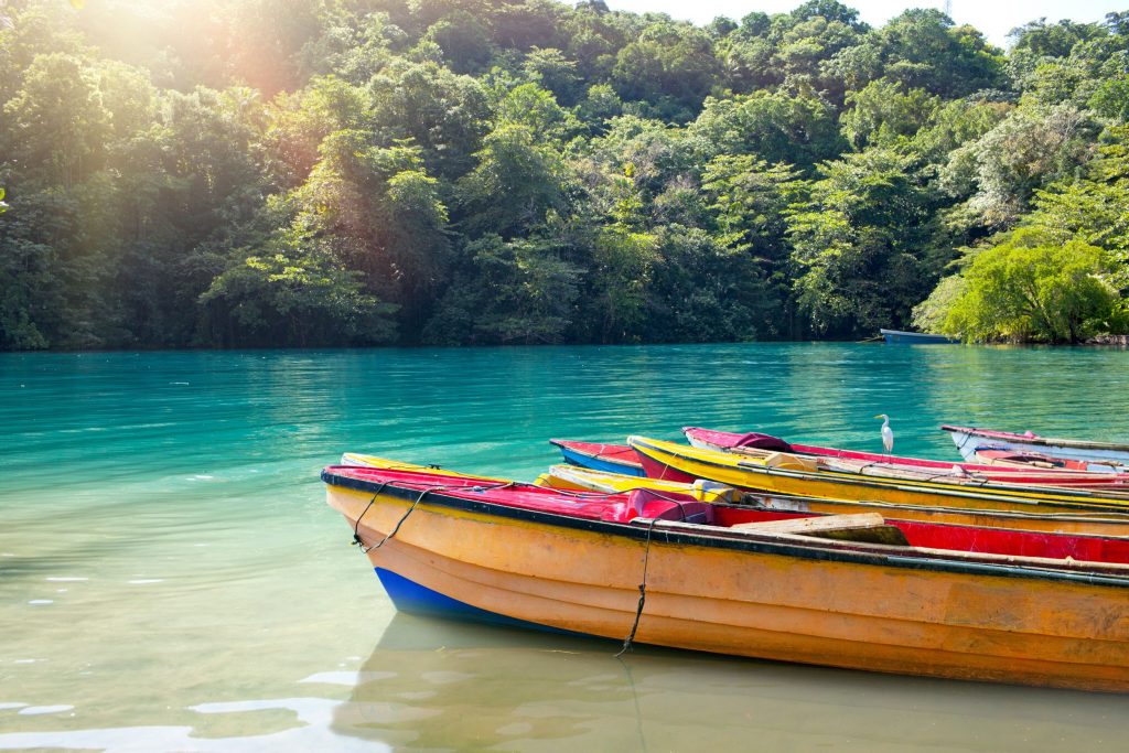 Colorful Boats in the Blue Lagoon in Jamaica. A beautiful destination for conscious traveller in Jamaica.